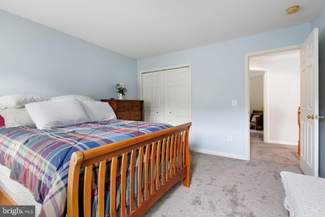  - carpeted bedroom featuring a closet and baseboards