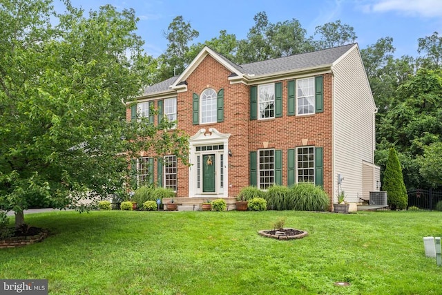  - view of front of home with a front yard and brick siding