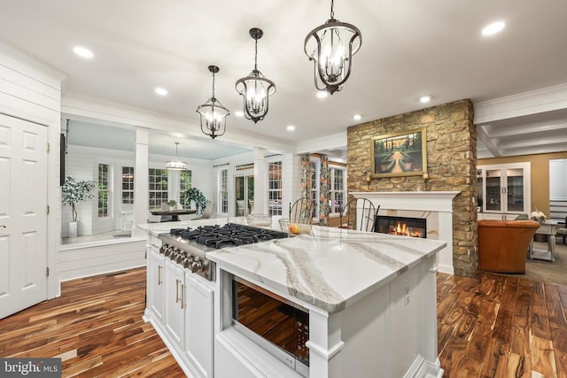 519 Cardinal Ln, Warrenton, VA 20186 - kitchen featuring stainless steel gas cooktop, dark wood-style flooring, a stone fireplace, open floor plan, and light stone counters