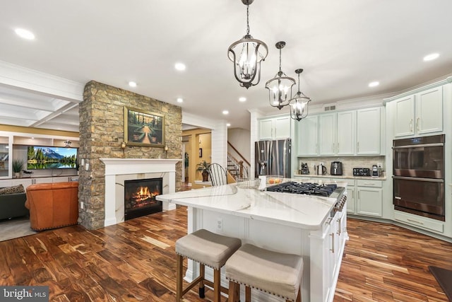 519 Cardinal Ln, Warrenton, VA 20186 - kitchen featuring appliances with stainless steel finishes, open floor plan, dark wood-style floors, a stone fireplace, and recessed lighting