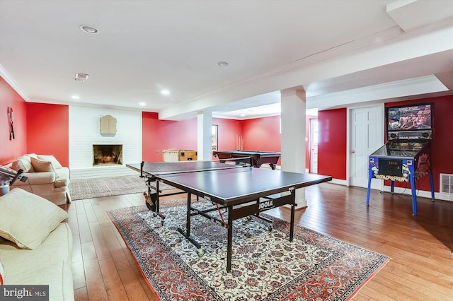 - rec room featuring ornamental molding, hardwood / wood-style flooring, a fireplace, billiards, and recessed lighting