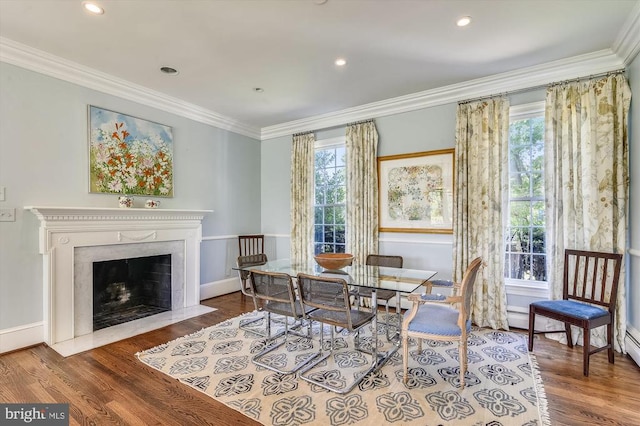  - dining room with ornamental molding, wood finished floors, a fireplace, baseboards, and recessed lighting