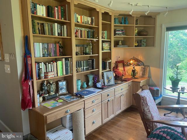  - sitting room featuring wood finished floors and track lighting