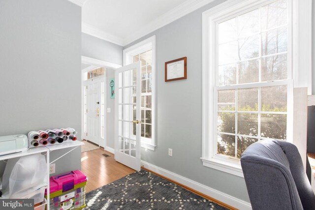 office area featuring crown molding, wood finished floors, french doors, plenty of natural light, and baseboards