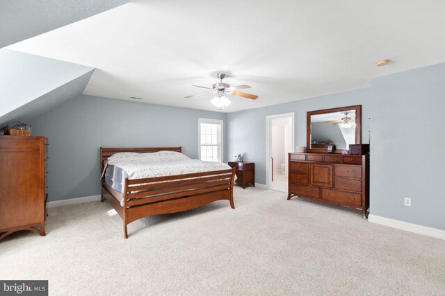 bedroom with light colored carpet, baseboards, and a ceiling fan