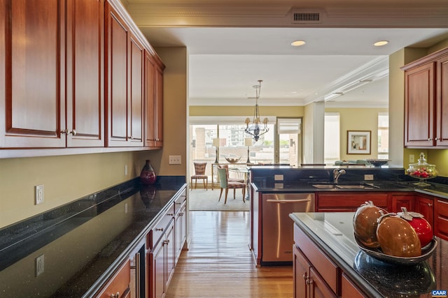 kitchen with a sink, dishwasher, ornamental molding, dark stone counters, and light wood finished floors