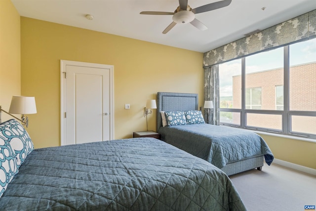 carpeted bedroom featuring baseboards and ceiling fan