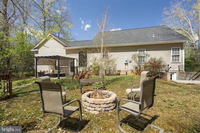 3704 Elk Creek Rd, Mineral, VA 23117 - back of house featuring roof with shingles, fence, a pergola, a lawn, and an outdoor living space with a fire pit