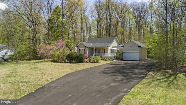 3704 Elk Creek Rd, Mineral, VA 23117 - ranch-style house with a front yard, an outbuilding, aphalt driveway, and covered porch