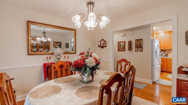 2273 Bloomer Springs Rd, Mcgaheysville, VA 22840 - dining room with a notable chandelier, light wood-type flooring, and baseboards