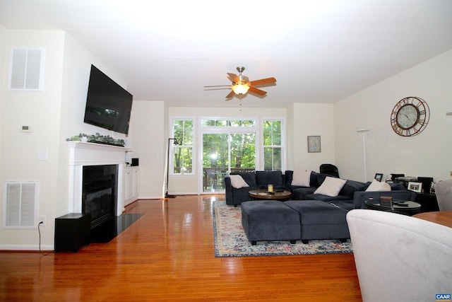 106 Melbourne Prk Cir Unit E, Charlottesville, VA 22901 - living room featuring wood finished floors, a fireplace with flush hearth, and ceiling fan