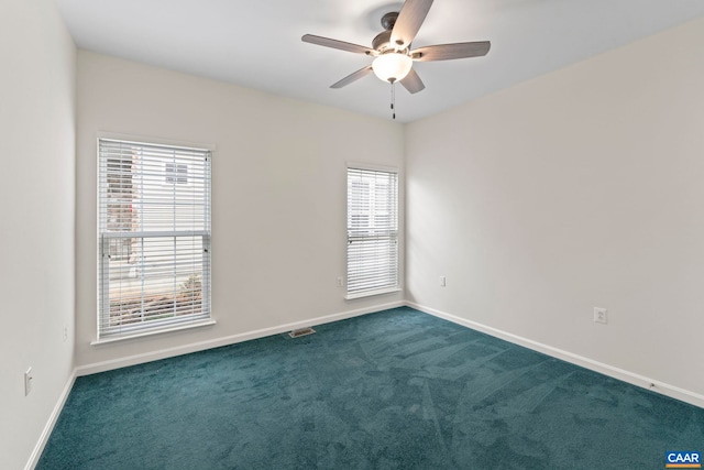 carpeted spare room featuring ceiling fan