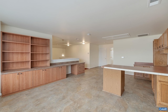 kitchen with built in desk and decorative light fixtures