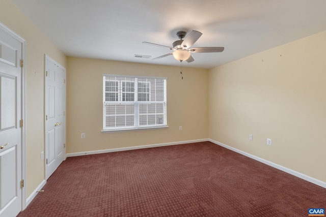 carpeted spare room with ceiling fan