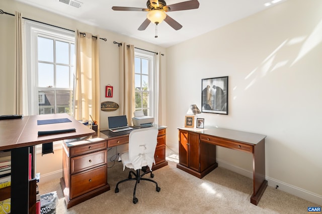 office area with a ceiling fan, light carpet, and baseboards