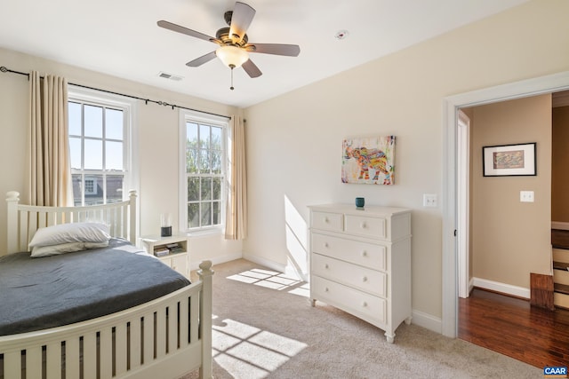 bedroom with baseboards, light carpet, and a ceiling fan