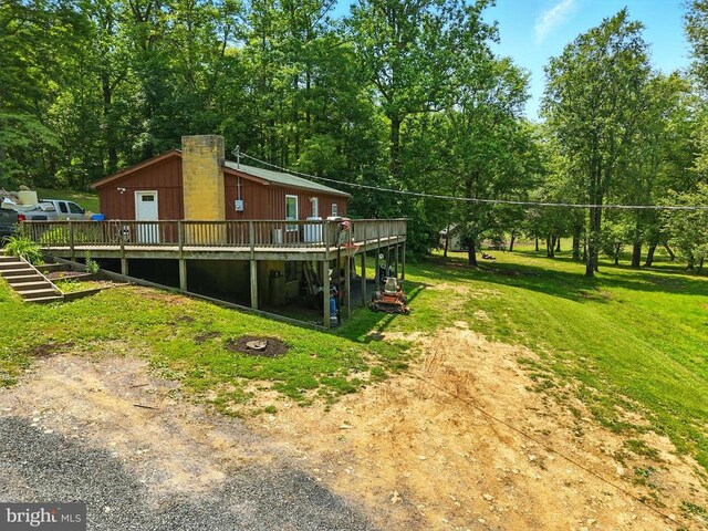  - view of grassy yard with a deck