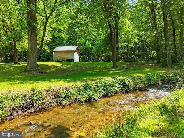  - view of green lawn with a view of trees