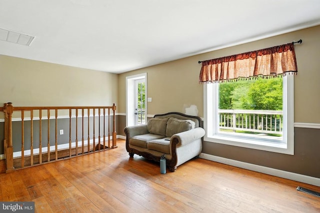  - living area with wood-type flooring and baseboards