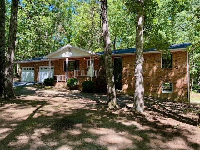 1655 Howardsville Tpke, Stuarts Draft, VA 24477 - single story home with an attached garage, brick siding, driveway, and a porch