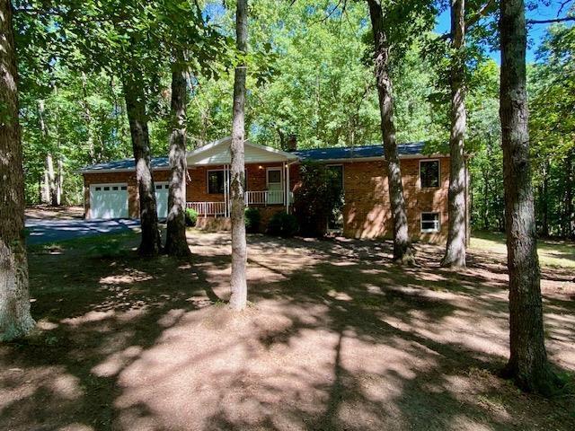 1655 Howardsville Tpke, Stuarts Draft, VA 24477 - ranch-style home with covered porch, an attached garage, and driveway