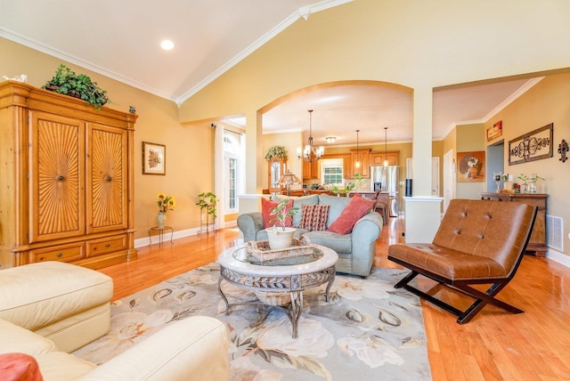3953 Cavalry Ln, Penn Laird, VA 22846 - living room with arched walkways, light wood finished floors, a chandelier, baseboards, and ornamental molding