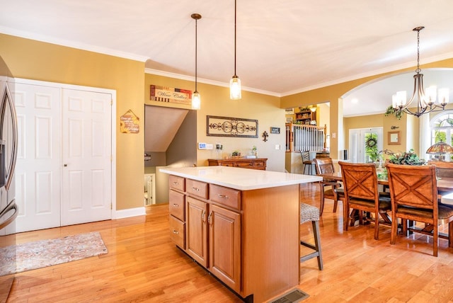 3953 Cavalry Ln, Penn Laird, VA 22846 - kitchen featuring light wood finished floors, a chandelier, a kitchen island, ornamental molding, and light countertops