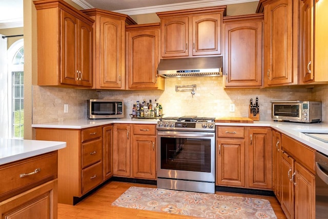 3953 Cavalry Ln, Penn Laird, VA 22846 - kitchen with stainless steel appliances, crown molding, extractor fan, light countertops, and light wood-style flooring