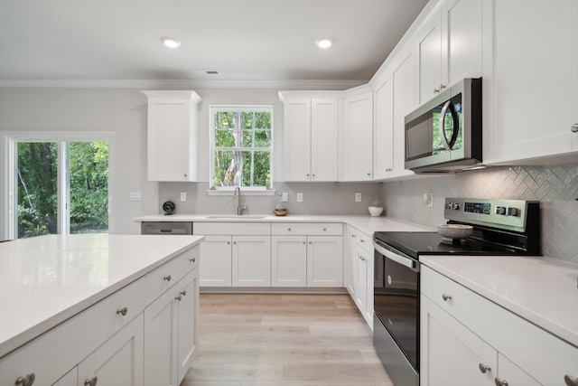 TBD Fairfield Dr, Staunton, VA 24401 - kitchen featuring appliances with stainless steel finishes, a sink, light countertops, crown molding, and light wood-type flooring
