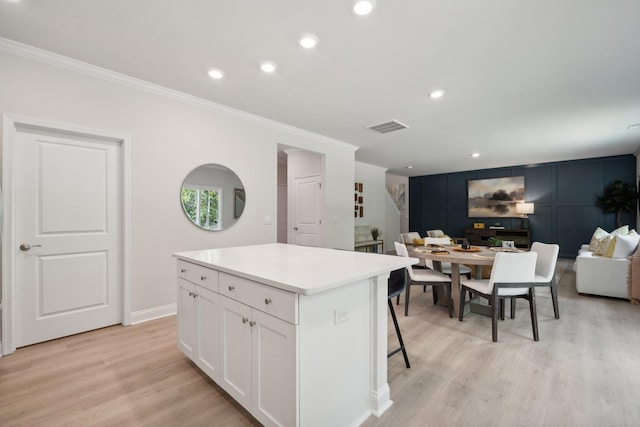 TBD Fairfield Dr, Staunton, VA 24401 - kitchen featuring crown molding, white cabinetry, a kitchen island, light wood-type flooring, and a kitchen bar