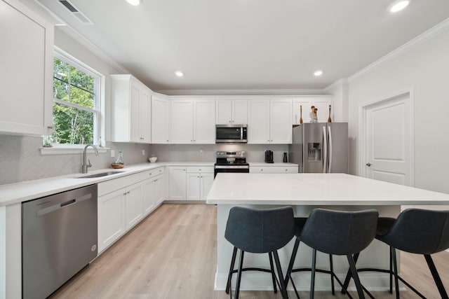 TBD Fairfield Dr, Staunton, VA 24401 - kitchen with appliances with stainless steel finishes, a sink, decorative backsplash, a kitchen breakfast bar, and crown molding