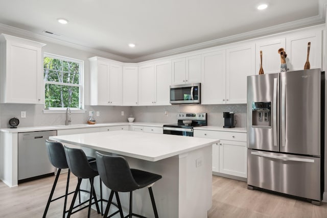TBD Fairfield Dr, Staunton, VA 24401 - kitchen with stainless steel appliances, a kitchen island, crown molding, light wood finished floors, and a kitchen bar