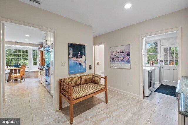 living area featuring independent washer and dryer, healthy amount of natural light, recessed lighting, and light tile patterned flooring