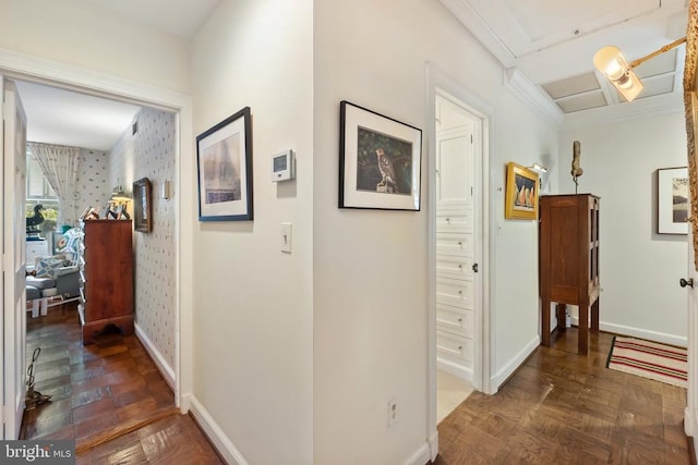 hallway with baseboards and wallpapered walls