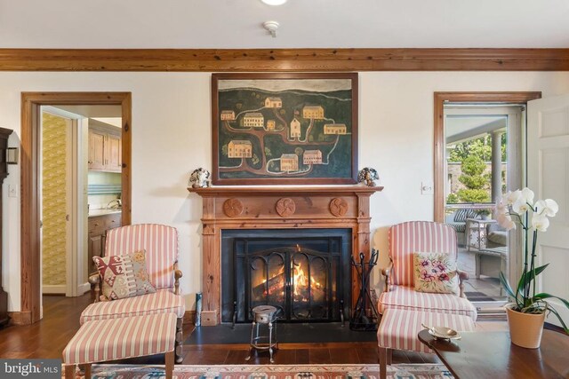 living area featuring a fireplace with flush hearth and wood finished floors
