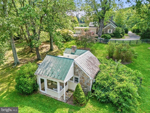 view of subject property featuring a tree filled landscape