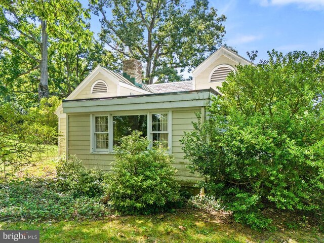 view of side of home featuring a chimney