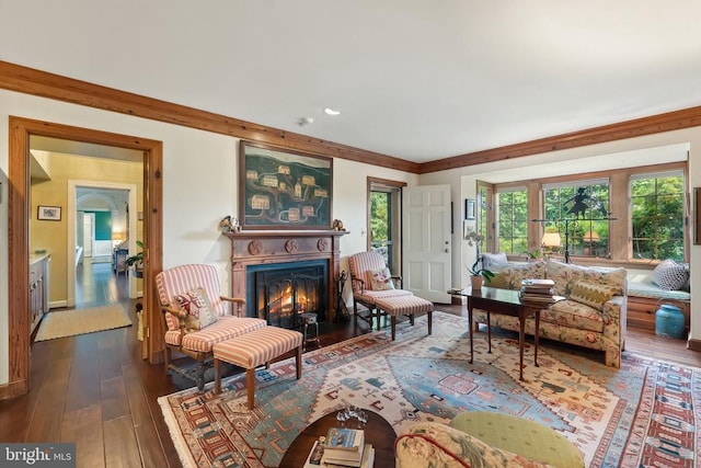 living area featuring hardwood / wood-style flooring and a glass covered fireplace