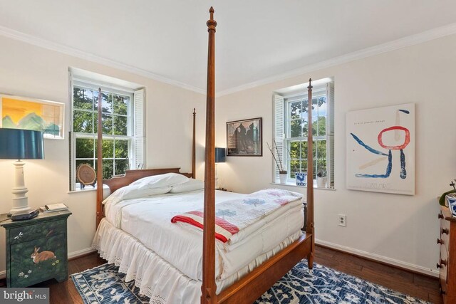 bedroom featuring crown molding, multiple windows, baseboards, and wood finished floors
