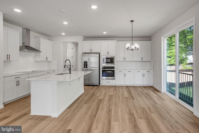 35607 Pine Needle Ln, Locust Grove, VA 22508 - kitchen with stainless steel appliances, wall chimney range hood, a sink, light wood-style floors, and recessed lighting