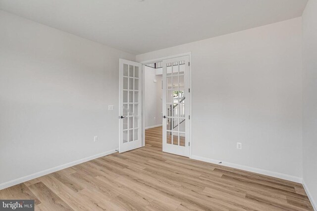 35607 Pine Needle Ln, Locust Grove, VA 22508 - spare room with french doors, baseboards, and light wood-style floors
