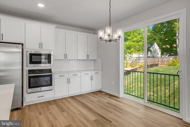 35607 Pine Needle Ln, Locust Grove, VA 22508 - kitchen featuring appliances with stainless steel finishes, light wood-style flooring, a chandelier, white cabinets, and recessed lighting