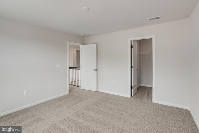 35607 Pine Needle Ln, Locust Grove, VA 22508 - unfurnished bedroom with carpet, baseboards, a walk in closet, and a closet