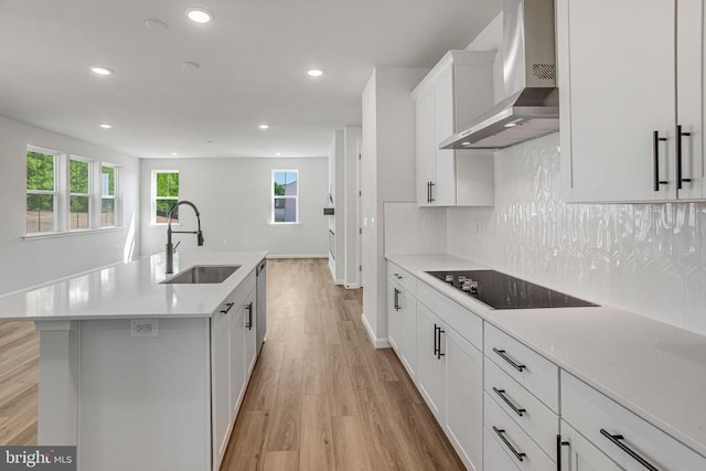 35607 Pine Needle Ln, Locust Grove, VA 22508 - kitchen with a sink, wall chimney exhaust hood, black electric stovetop, light wood-type flooring, and recessed lighting