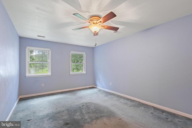  - carpeted spare room with baseboards and ceiling fan