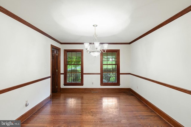  - spare room featuring a chandelier, wood finished floors, and ornamental molding