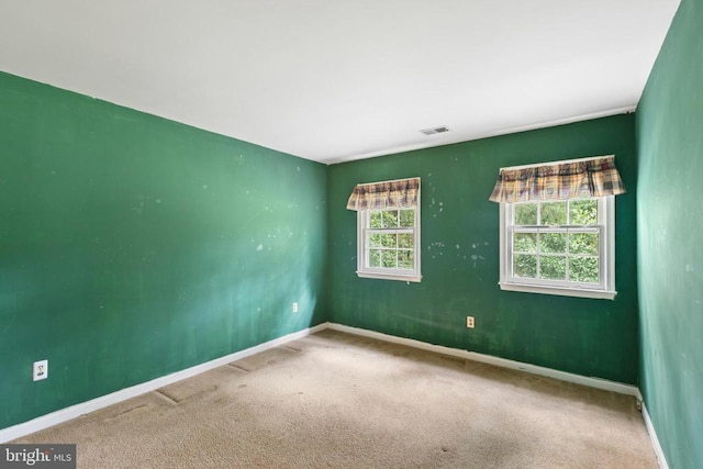  - spare room featuring baseboards and carpet floors