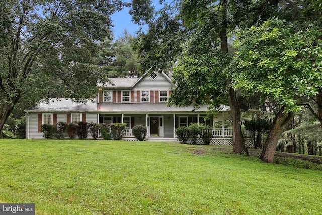  - view of front facade featuring a porch and a front yard