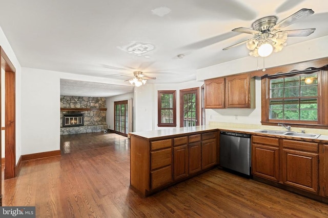  - kitchen featuring dishwasher, brown cabinets, ceiling fan, and dark wood-style flooring