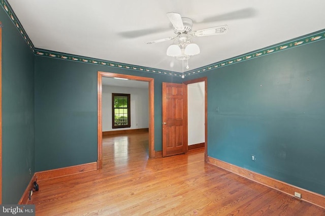  - spare room with wood finished floors and ceiling fan